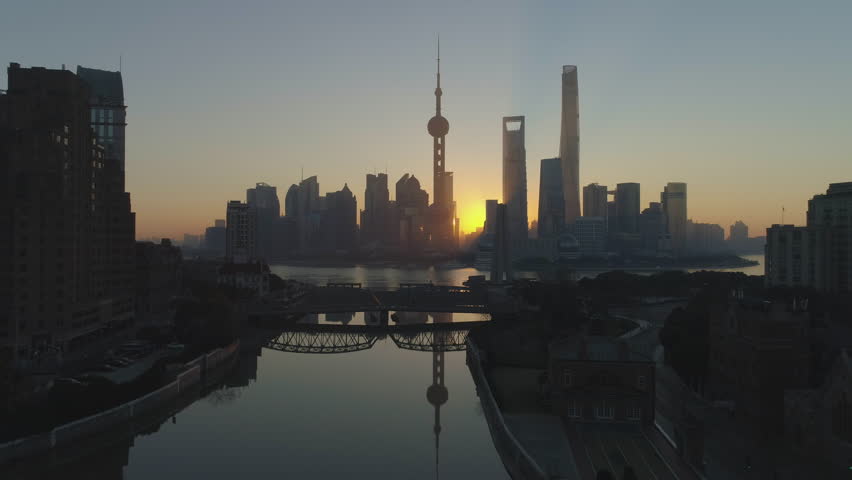 Panoramic Shanghai Skyline at Sunrise. Lujiazui Financial District and Huangpu River. China. Aerial View. Drone is Flying Forward and Upward. Establishing Shot.

