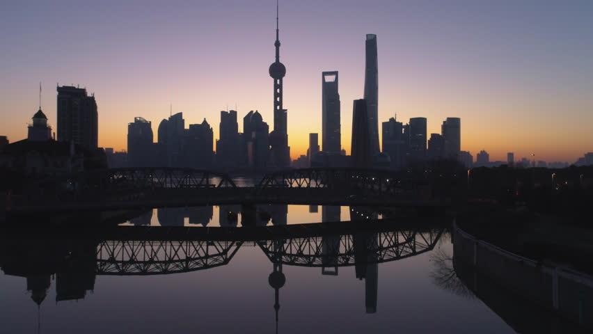 Panoramic Shanghai Skyline Silhouette at Dawn. Lujiazui Financial District and Huangpu River. China. Aerial View. Drone is Flying Upward. Establishing Shot.
 Royalty-Free Stock Footage #1007214766
