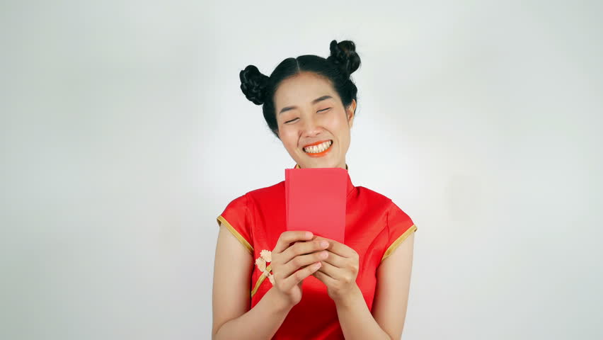 4k video of beautiful woman wear cheongsam and holding red envelope and counting money in concept of happy chinese new year