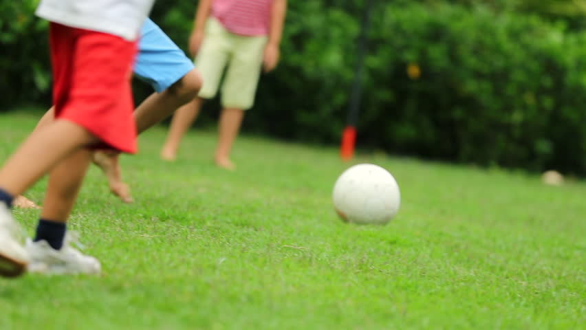 Children running after soccer ball. Kids playing football on the home lawn | Shutterstock HD Video #1007232013