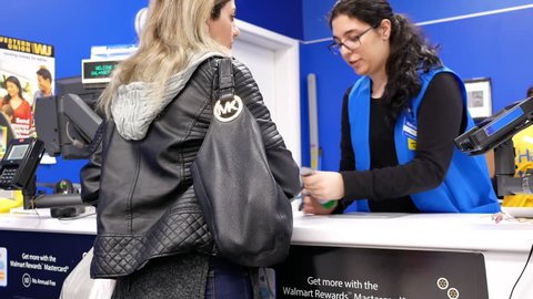 Coquitlam, BC, Canada - February 04, 2018 :  Motion of people returning items at customer service counter inside Walmart store with 4k resolution