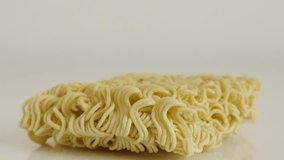 Popular staple food block close-up 4K 2160p 30fps UltraHD footage - Instant Chinese noodles on white background  slow tilt 3840X2160 UHD video