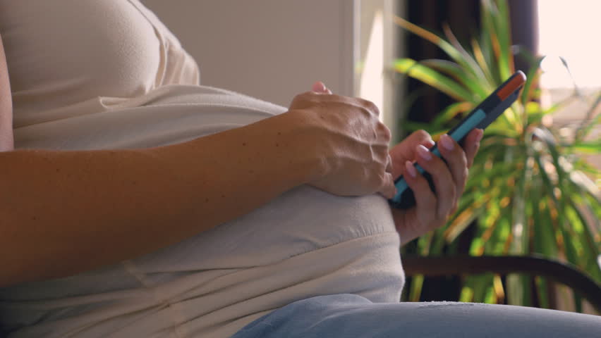 hands pregnant woman touching belly using: стоковое видео (без лицензионных...