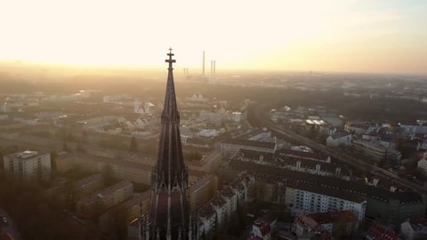 aerial shot of the tip of a church in the Bavarian capital Munich during the sunset in the evening light