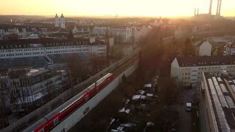 aerial shot of a train in the Bavarian capital Munich during the sunset in the evening light
