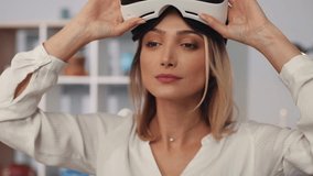 CLose up cute young woman wearing virtual reality glasses waving his hands sit on the sofa at home feel happy smiling innovation looking entertainment gadget new tech visual game hipster slow motion