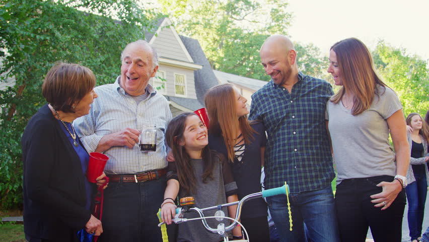 Group of neighbours smiling to camera at a block party