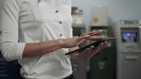 Businesswoman use digital tablet on ATM background, bank work, business woman withdrawal - Powered by Shutterstock - Get 15% off with code: PIKWIZARD15