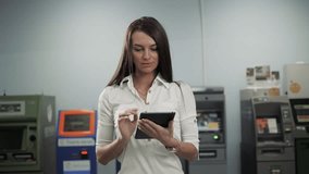 Businesswoman use digital tablet on ATM background, bank work, business woman withdrawal - Powered by Shutterstock - Get 15% off with code: PIKWIZARD15