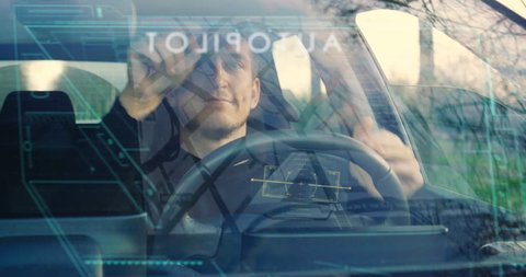A man drives his futuristic car and when he activates the autopilot the car drives itself and can relax. Concept of: Technology, holography, future, transport and cars.