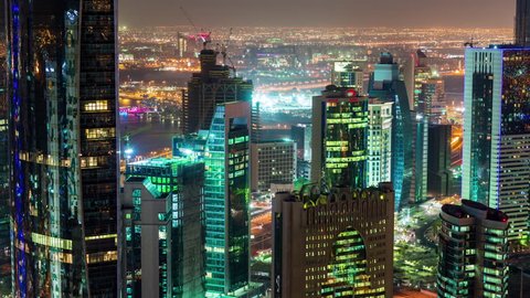 DOHA, QATAR - JUNE 30th 2017: skycreapers tall buildings timelapse night downtown streets, Middle East