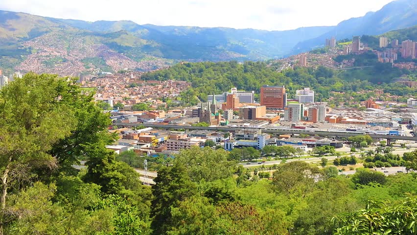 Colombia Medellin aerial view of the city and the surface metro bridge. Real time video