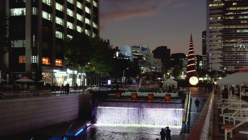 Illuminated waterfall of the Cheonggye Stream (Cheonggyecheon) at downtown of Seoul, South Korea. The Cheonggye Stream is a popular among residents and tourists modern public recreation space.