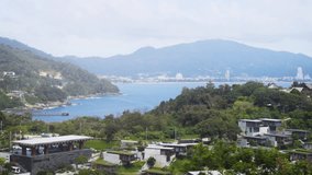 Distant view of Patong beach from an elevated perspective. as seen from a hillside across the bay. 4k video