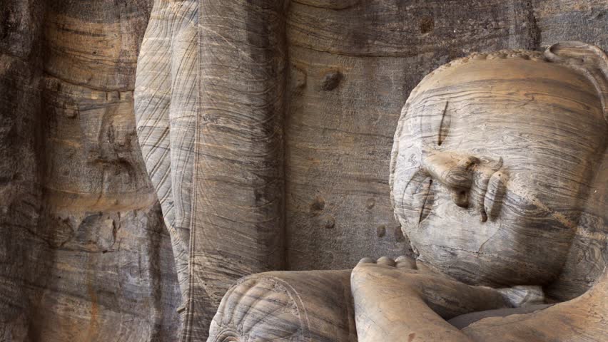 Ancient. stone Buddha sculpture at Gal Vihara. reclining on its side with a pillow. an important religious site in Polonnaruwa. Sri Lanka. 4k video