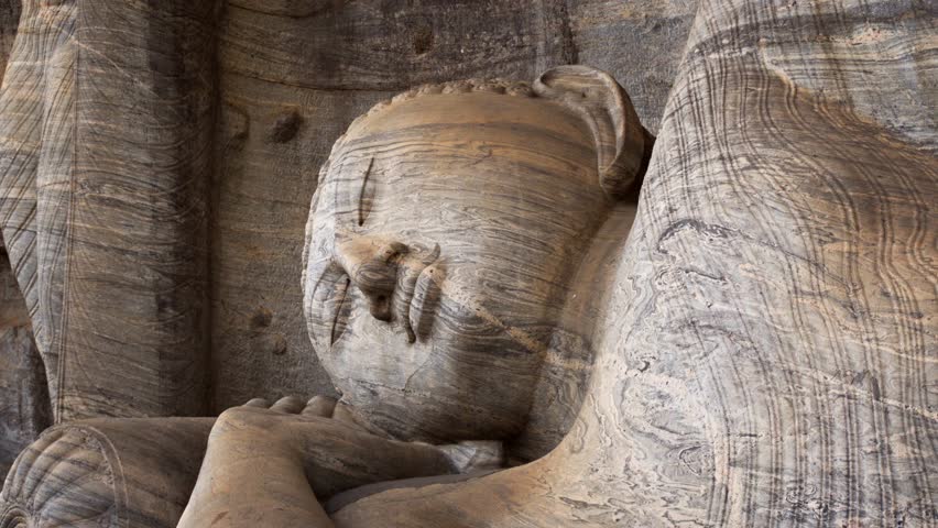 Ancient. stone Buddha sculpture at Gal Vihara. reclining on its side with a pillow. an important religious site in Polonnaruwa. Sri Lanka. 4k video