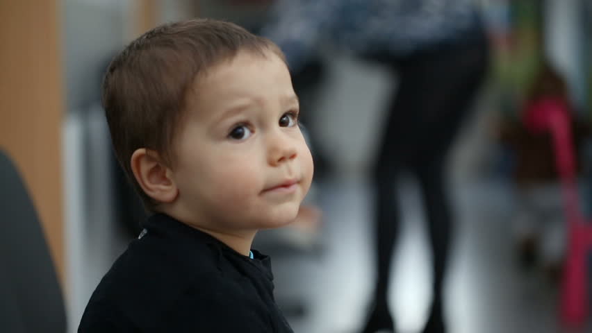 Small boy sitting in the waiting room in hospital
