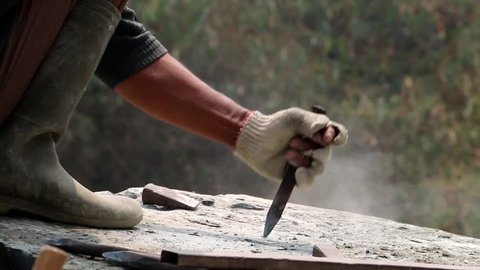 Chopping A Stone With A Chisel And A Hammer