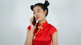 4k video of happy woman wear cheongsam and using mobile phone on a white background