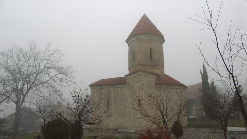 The ancient Albanian Church of Saint Elisha in january on a foggy day. Kish village, Azerbaijan