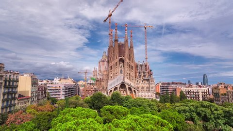 BARCELONA, CATALONIA - JULY 26th 2017: Timelapse of Sagrada familia Gaudi architecture city centre old buildings rooftop streets