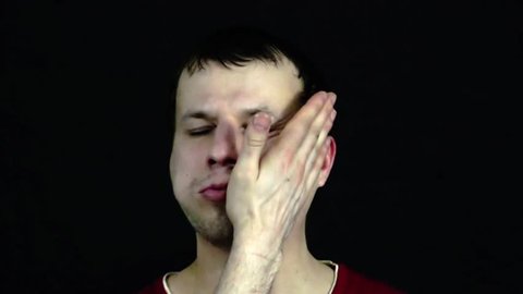 A young man gets in the face with a hand
