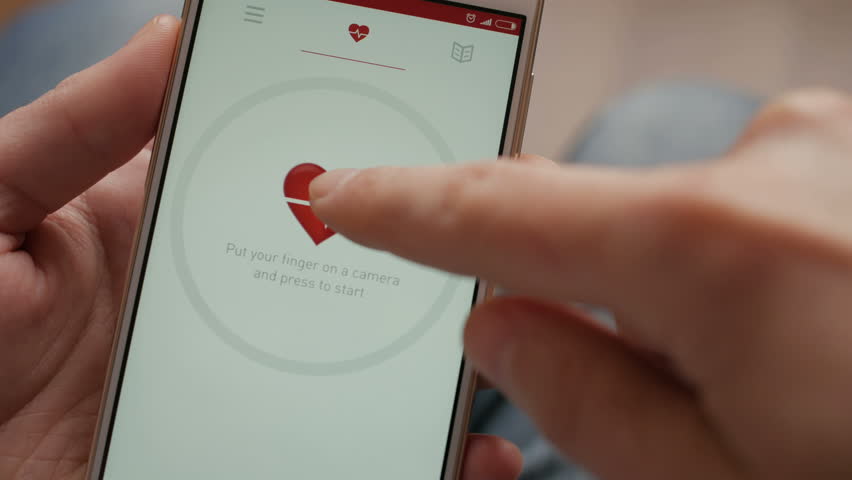 Man Looking At Health Monitoring App On Smartphone. Monitoring the heart pulse with a health application on smartphone. Royalty-Free Stock Footage #1007336488