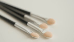 Accessories for beauty treatment close-up 4K 2160p 30fps UltraHD tilting video - Set of eyeshadow makeup brushes slow tilt 3840X2160 UHD footage