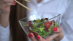 4k video of elegant businesswoman having lunch on her working place. Woman eating vegetable salad in office. 4 k Close-up