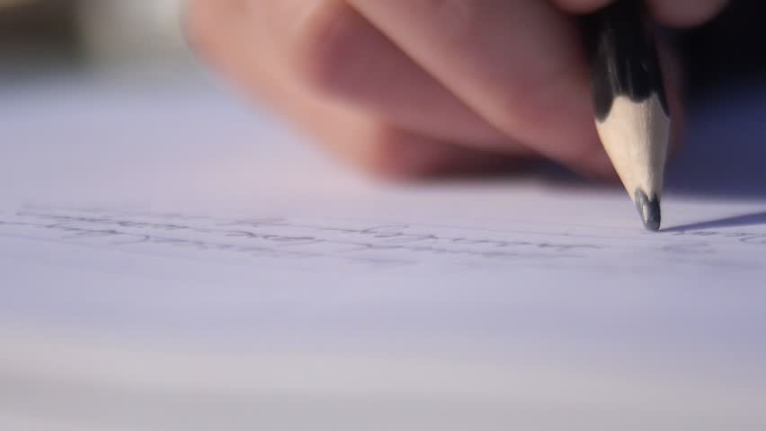 Close up of a female hand writing with a pencil on a notebook - Slow motion Royalty-Free Stock Footage #1007343664