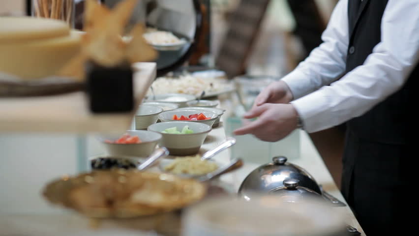 The buffet in the restaurant. The waiter serves the table Royalty-Free Stock Footage #1007345806