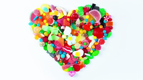 a large collection of sweets and candy made into a heart shape