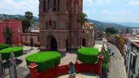 Drone video of Parroquia de San Miguel Arcangel, an old cathedral, in Guanajuato, Central Mexico.