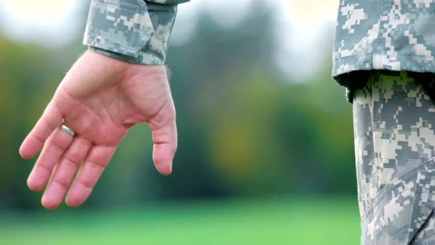 Hands of father and child. Holding hands of military soldier in uniform.