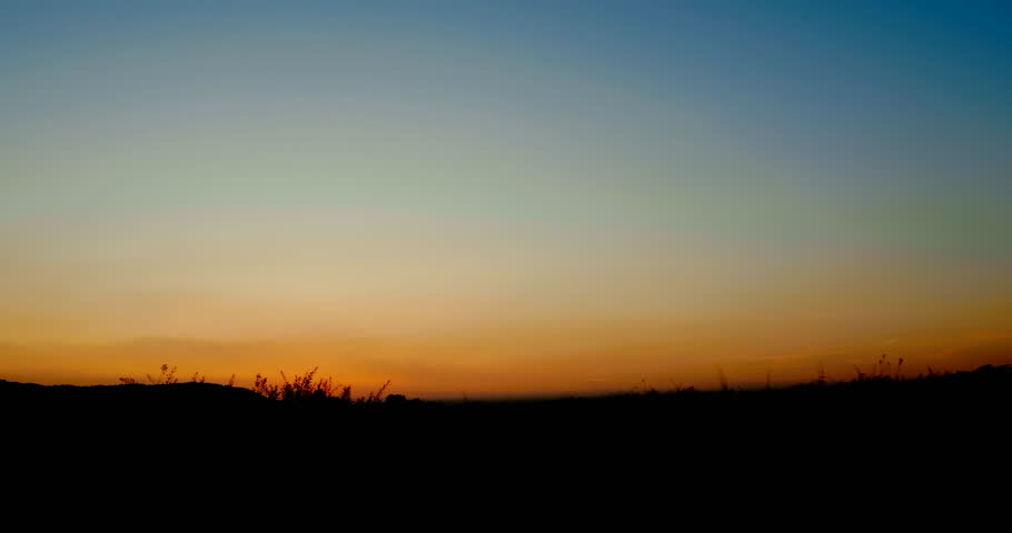 Side shot - Silhouette of family riding bikes in beautiful summer evening.
