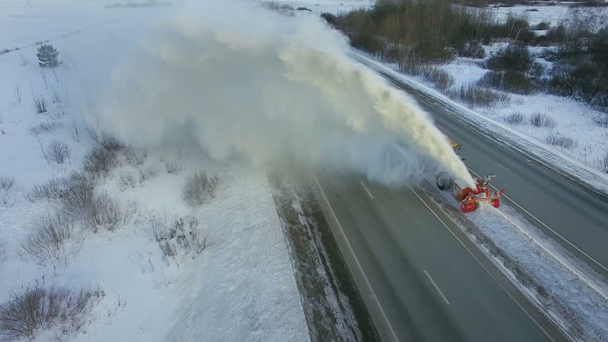Grader clean remove snow, snowplow, snow blower, blast snowfall, winter, road, special vehicle on the highway, cool frozen fountain of snow aerial view