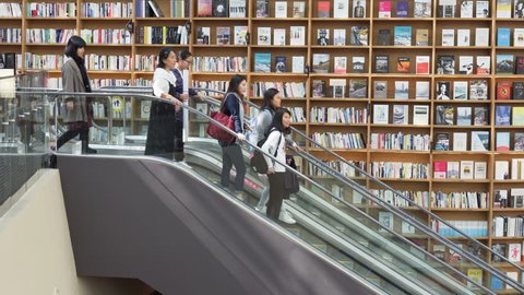 Seoul, South Korea - October 14, 2017: Escalator at Starfield Library. Visitors moving between floors of the public library with huge bookshelves.