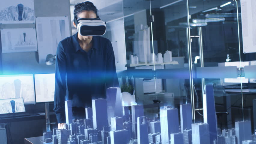 Professional Female Architect Wearing Makes Gestures with Augmented Reality Headset, Shows Statistics for 3D City Model. High Tech Office Use Virtual Reality Modeling Software Application. Royalty-Free Stock Footage #1007401252