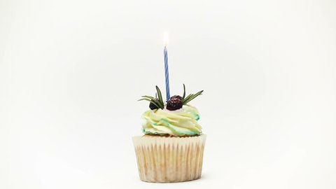 holiday, celebration, greeting and party concept - birthday cupcake with five burning candles over yellow background
