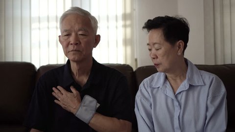 Asian senior couple do self blood pressure check
