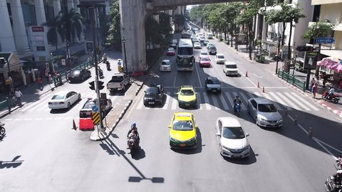 Bangkok, Thailand - January 2, 2017 - Traffic and people cross the road at Ratchaprasong intersection