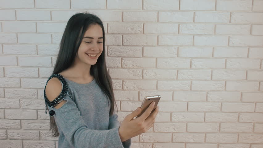 Beautiful girl with a phone. The girl is talking on the phone.