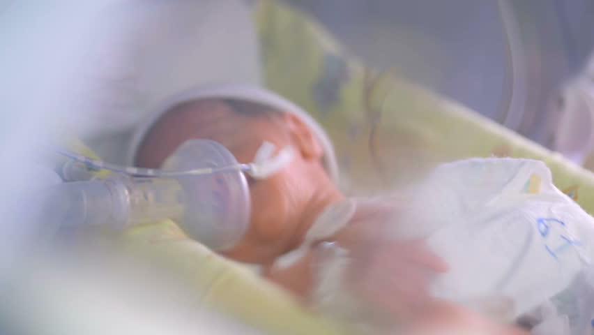Close up of an unrecognizable new born premature baby in incubator. 4K. Royalty-Free Stock Footage #1007429947