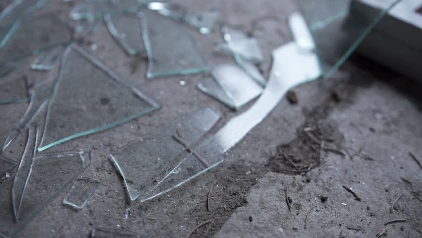 Broken window glass shattered on a dirty grungy ground. Royalty-Free Stock Footage #1007430037
