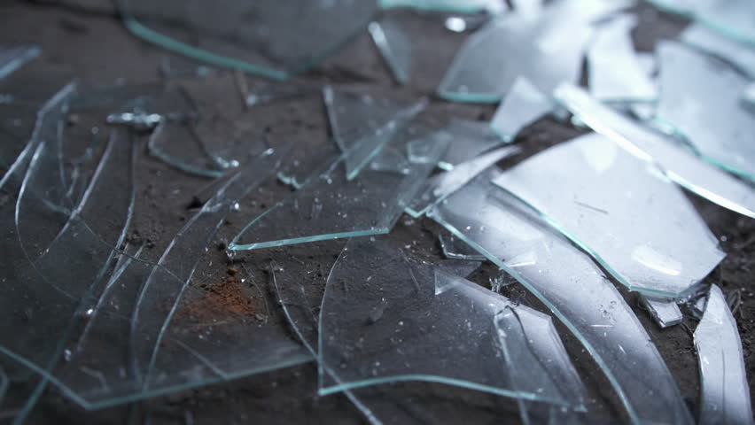 Broken window glass shattered on a dirty grungy ground. Royalty-Free Stock Footage #1007430046