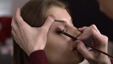 make-up artist draws hands closeup model