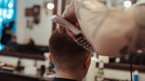 Barber makes a man's haircut. Body care. Video retro toning. Dynamic frame shaking.