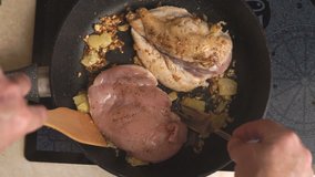 Man fries a chicken breast with ginger