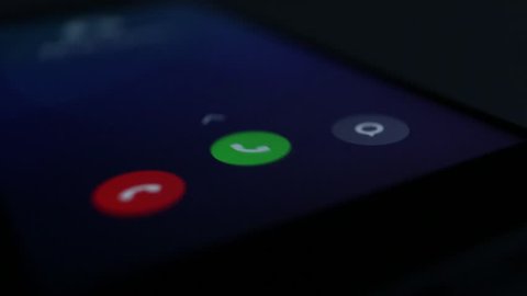 Incoming phone call indication on smartphone display close-up, Answering an incoming call