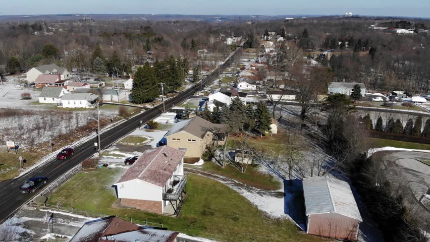 A fast flyover of typical Western Pennsylvania residential homes on a sunny winter day. Pittsburgh suburbs.  	